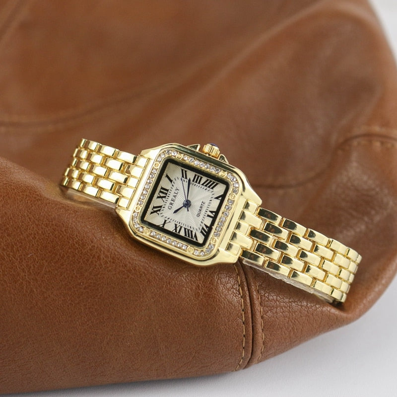 Relógio feminino Grealy com pulseira refinada e mostrador minimalista em tons dourados e brancos