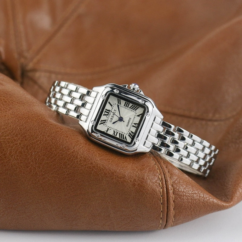 Relógio feminino Grealy com pulseira refinada e mostrador minimalista em tons dourados e brancos